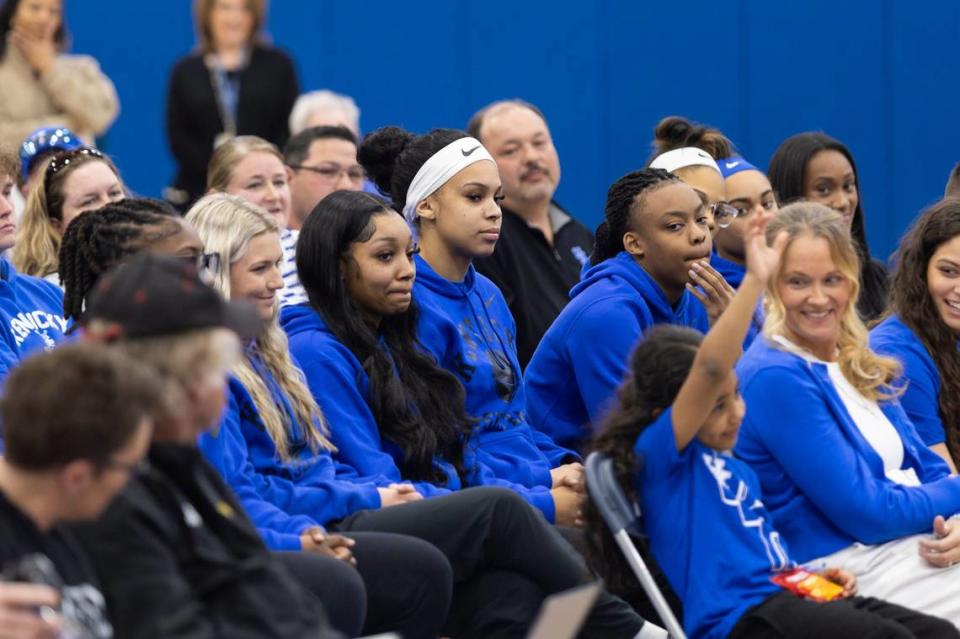 Members of the Kentucky women’s basketball team watch new head coach Kenny Brooks’ introductory news conference Thursday.