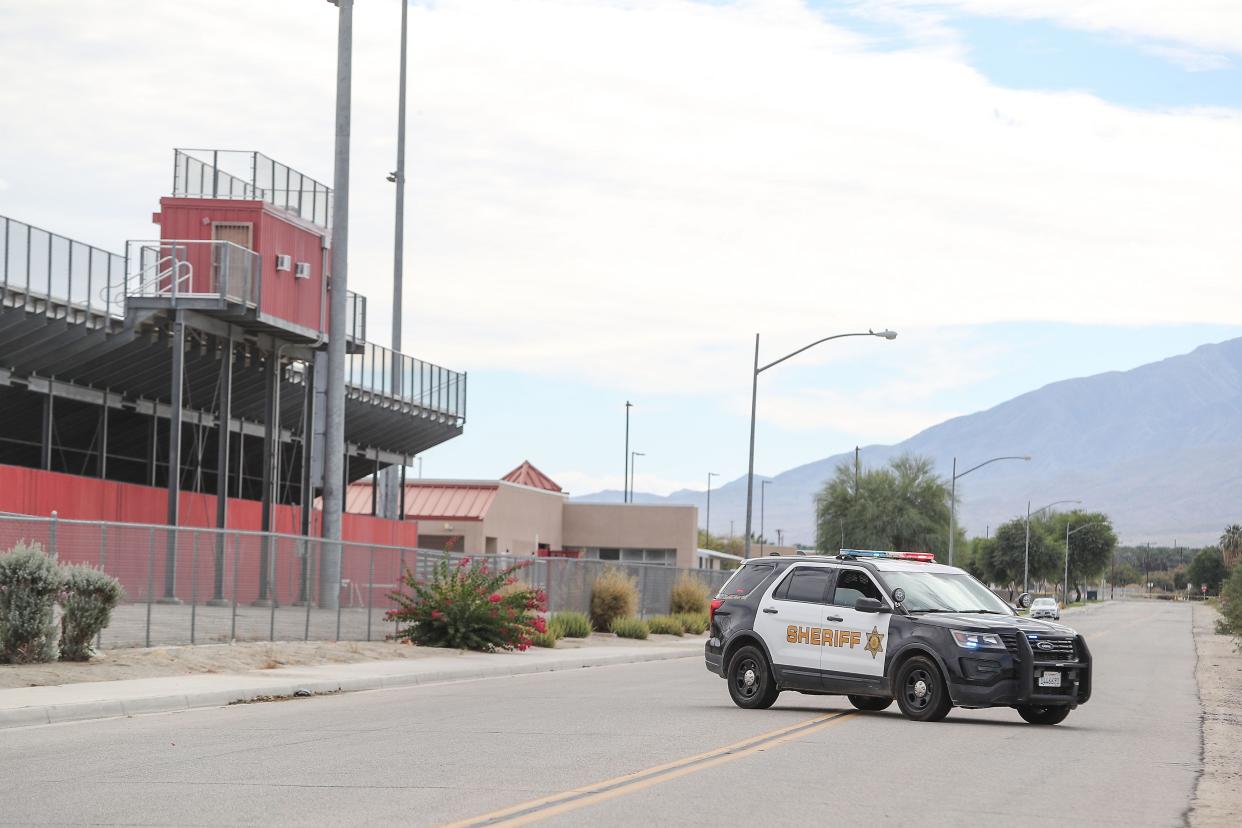 Riverside County sheriff's deputies block the roads around Toro Canyon Middle and Desert Mirage High schools on Wednesday.