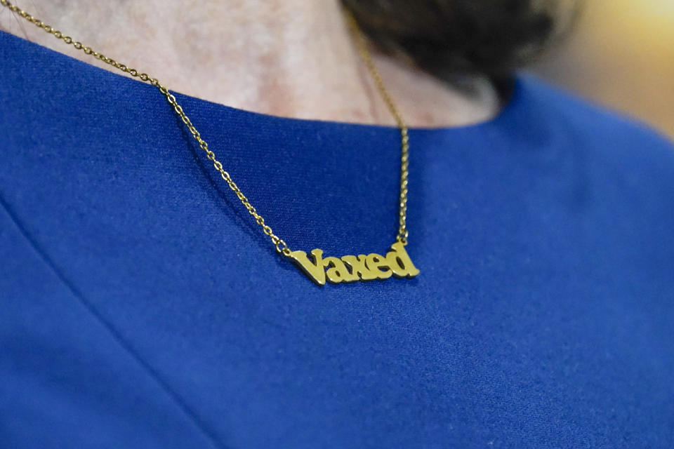 New York Gov. Kathy Hochul wears a "Vaxed" necklace during an event, Friday, Dec. 10, 2021, in New York. Hochul announced that masks will be required in all indoor public places in New York State unless the businesses or venues implement a vaccine requirement. (AP Photo/Mary Altaffer)