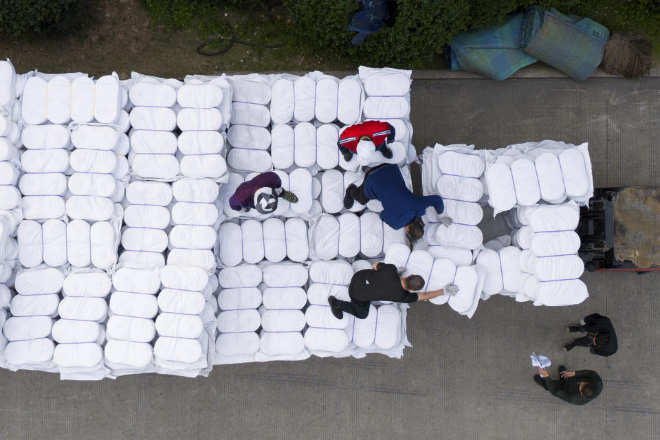 Plastic wrapped cotton meant for overseas markets are loaded for transportation from the Wenzhou Tiancheng Textile Company, one of China's largest cotton recycling plants in Wenzhou in eastern China's Zhejiang province on March 20, 2024. (AP Photo/Ng Han Guan)