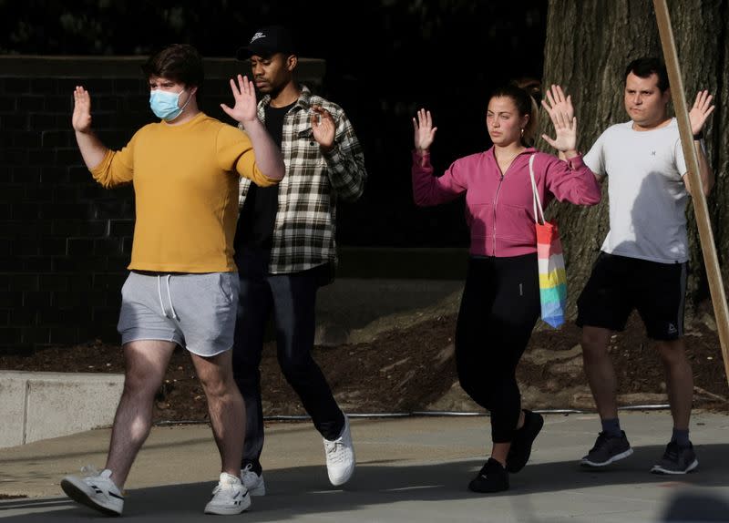 FILE PHOTO: Law enforcement officers evacuate local residents to safety near scene of a reported shooting near the Edmund Burke School in Washington