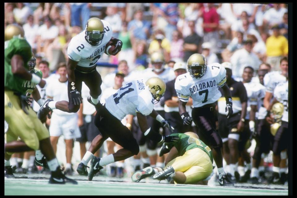 12 Sep 1992: Cornerback Deon Figures of the Colorado Buffaloes leaps over a teammate during a game against the Baylor Bears at Floyd Casey Stadium in Baylor, Texas. Colorado won the game 57-38.