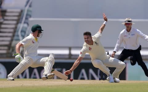 James Anderson fields off his own bowling as Cameron Bancroft scrambles for the crease - Credit: AP