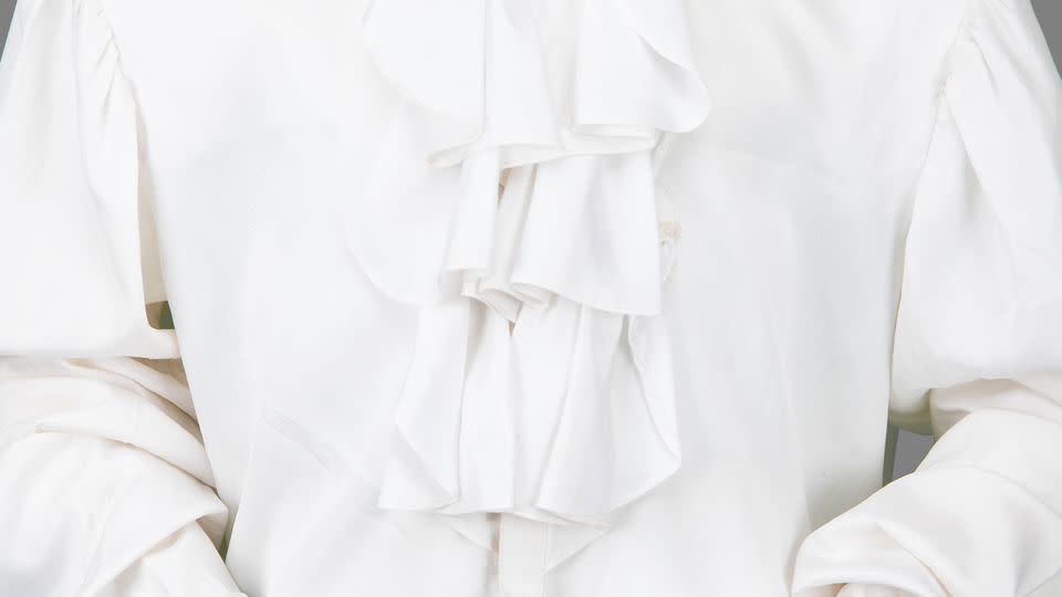 Bids for the silk shirt, with high neck, ruffles and puffy sleeves, have so far reached $15,000. - RR Auction