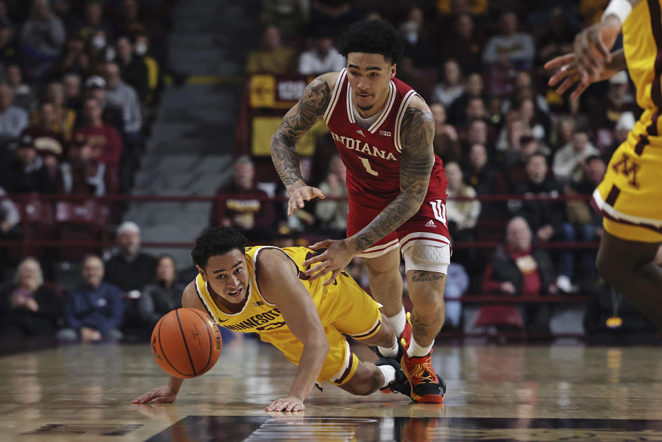 Minnesota guard Taurus Samuels (0) and Indiana guard Jalen Hood-Schifino (1) scramble for the ball during the second half of an NCAA college basketball game Wednesday, Jan. 25, 2023, in Minneapolis. Indiana won 61-57. (AP Photo/Stacy Bengs)