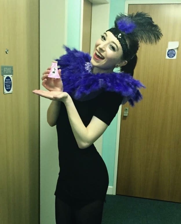 girl in a purple feather boa