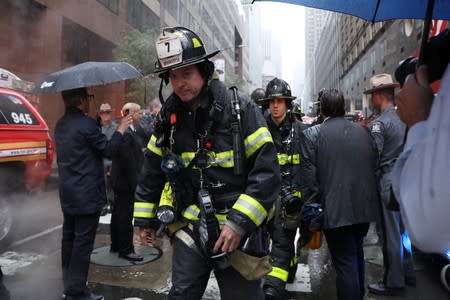 New York City Fire Department firefighters outside 787 7th Avenue in midtown Manhattan where helicopter crashed in New York