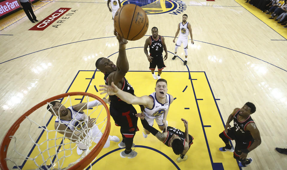 Toronto Raptors center Serge Ibaka, middle left, blocks a shot by Golden State Warriors forward Jonas Jerebko (21) during the second half of Game 3 of basketball's NBA Finals in Oakland, Calif., Wednesday, June 5, 2019. (AP Photo/Ezra Shaw, Pool)