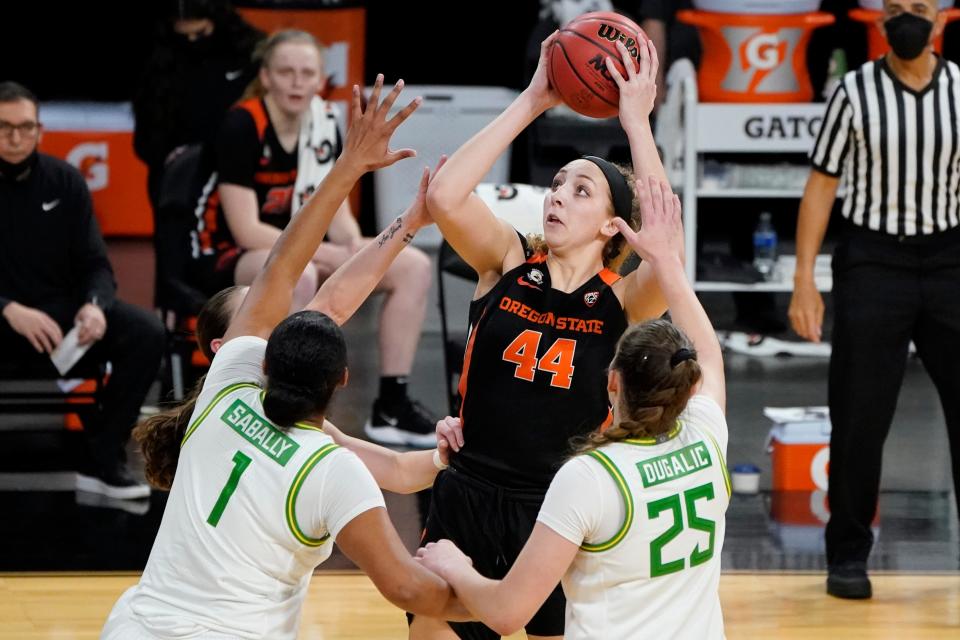 Oregon State forward Taylor Jones shoots over Oregon defenders during a game in the 2021 Pac-12 Tournament. After three years at Oregon State, Jones announced Saturday that she will transfer to Texas, which is in need of more post players.