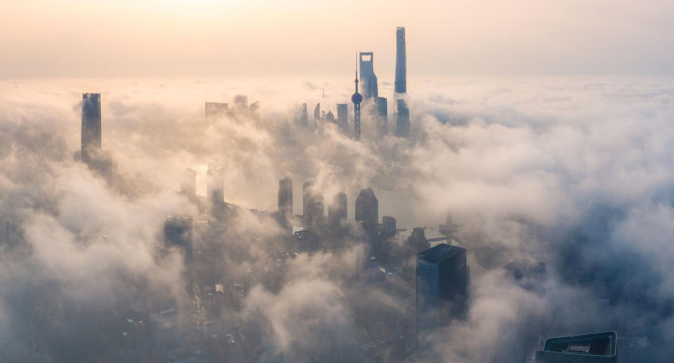 Photo of fog blanketing a city skyline. Changes in air movements can cause severe turbulence on a flight. 
