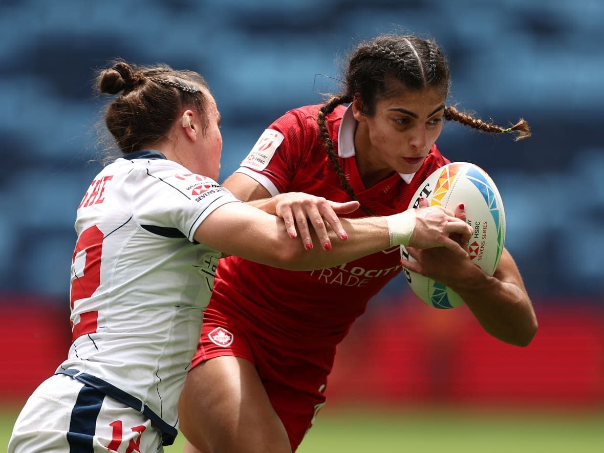 Canadian rugby sevens player Bianca Farella, right, is tackled during her team's 14-12 loss to the United States on Thursday at the Sydney Sevens tournament in Sydney, Australia. (Matt King/Getty Images - image credit)