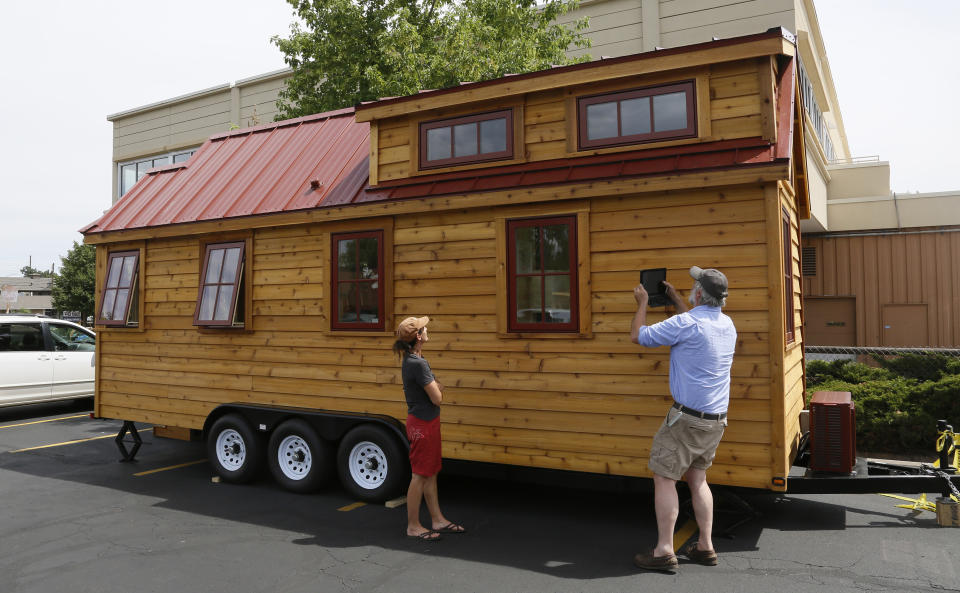 A man takes a picture of a Tumbleweed brand Cypress 24 model Tiny House on display in Boulder, Colorado, on August 4, 2014. (Photo: REUTERS/Rick Wilking)