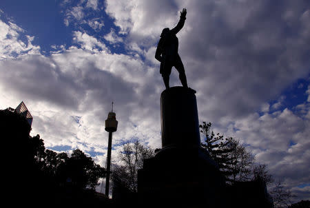 Sydney Tower can be seen behind a statue of British explorer Captain James Cook, which includes the inscription 'Discovered this Territory 1770', as it stands in Hyde Park located in central Sydney, Australia, August 24, 2017. REUTERS/David Gray