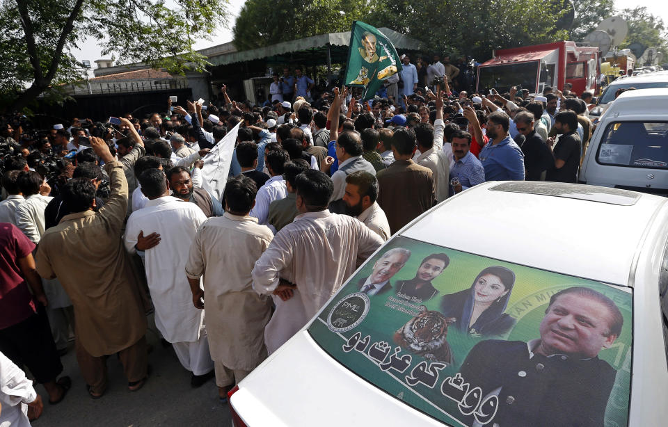 Supporters of former Pakistani Prime Minister Nawaz Sharif celebrate a court ruling, outside the Islamabad High Court in Islamabad, Pakistan, Wednesday, Sept. 19, 2018. The Pakistani court suspended the prison sentences of Sharif, his daughter and son-in-law on Wednesday and set them free on bail pending their appeal hearings. The court made the decision on the corruption case handed down to the Sharifs by an anti-graft tribunal earlier this year. (AP Photo/Anjum Naveed)