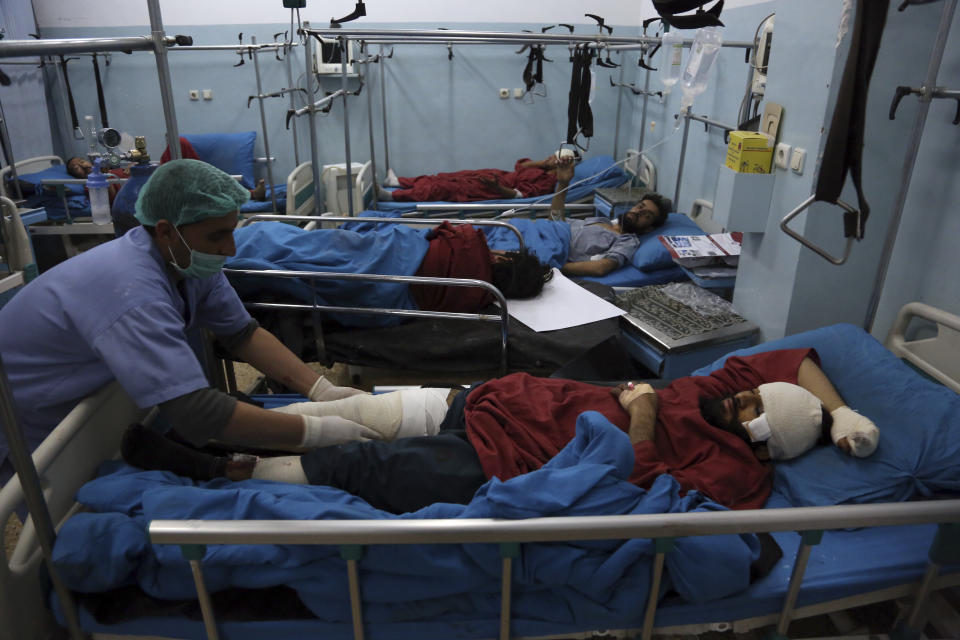 Injured men receive treatment at a hospital after a suicide bombing in Kabul, Afghanistan, Nov. 20, 2018. Afghan officials said the suicide bomber targeted a gathering of Muslim religious scholars in Kabul. (AP Photo/Rahmat Gul)