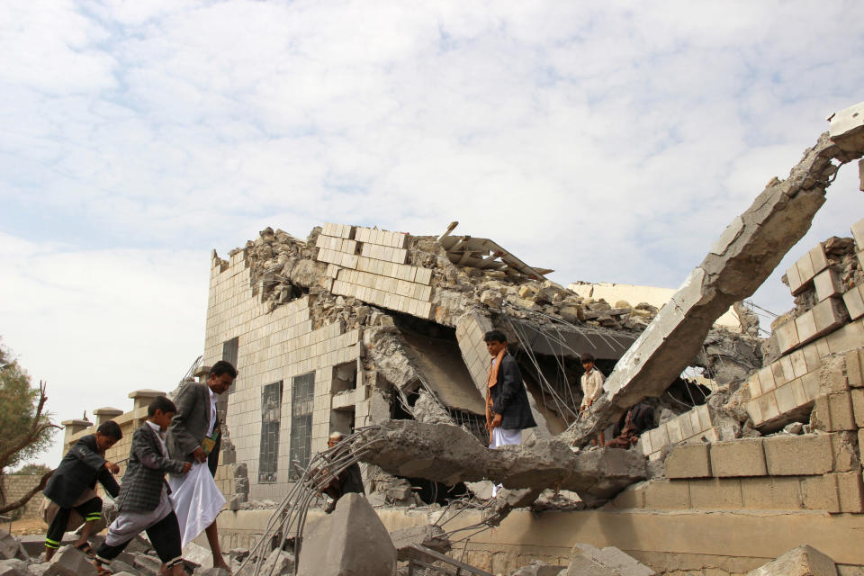 People walk on the rubble of a school destroyed by a Saudi-led air strike in an outskirt of the northwestern city of Saada, Yemen September 14, 2016. REUTERS/Naif Rahma