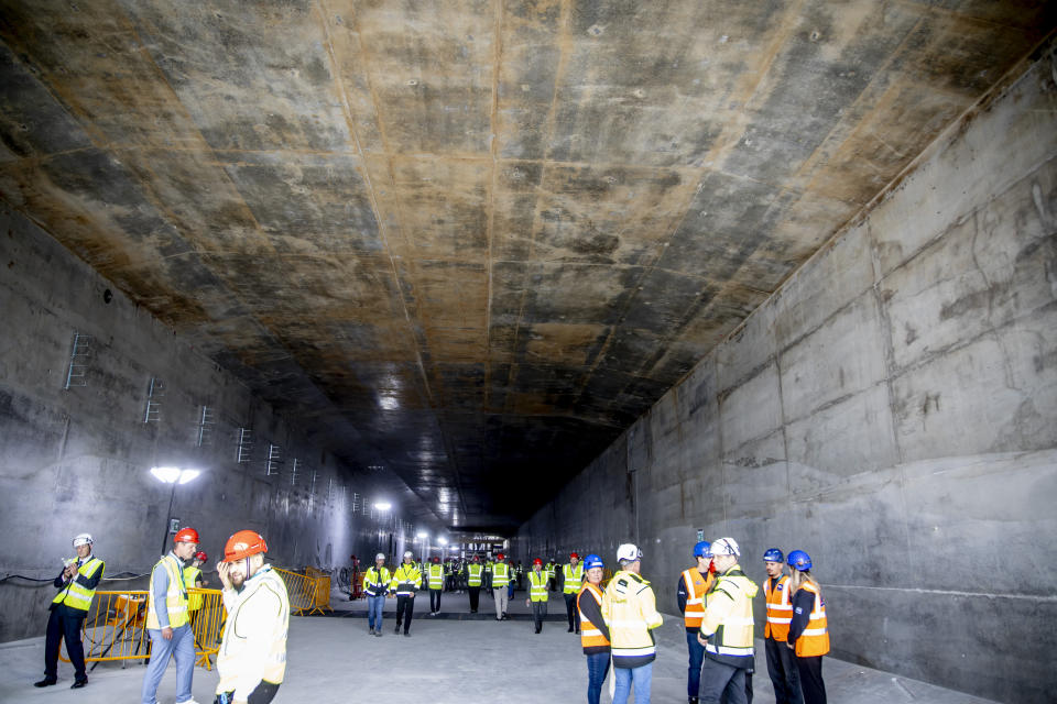 Workers are seen during the visit of Denmark's King Frederik X, to the Fehmarn Belt tunnel construction site at Roedbyhavn as he inaugurates the first tunnel element, on the island of Lolland, Denmark, Monday June 17, 2024. Danish King Frederik X inaugurated Monday the first element of a future 18-kilometer (11-mile) rail-and-road tunnel under the Baltic Sea that will link southern Denmark to northern Germany and contribute to the transport sector's green transition. (Ingrid Riis/Ritzau Scanpix via AP)