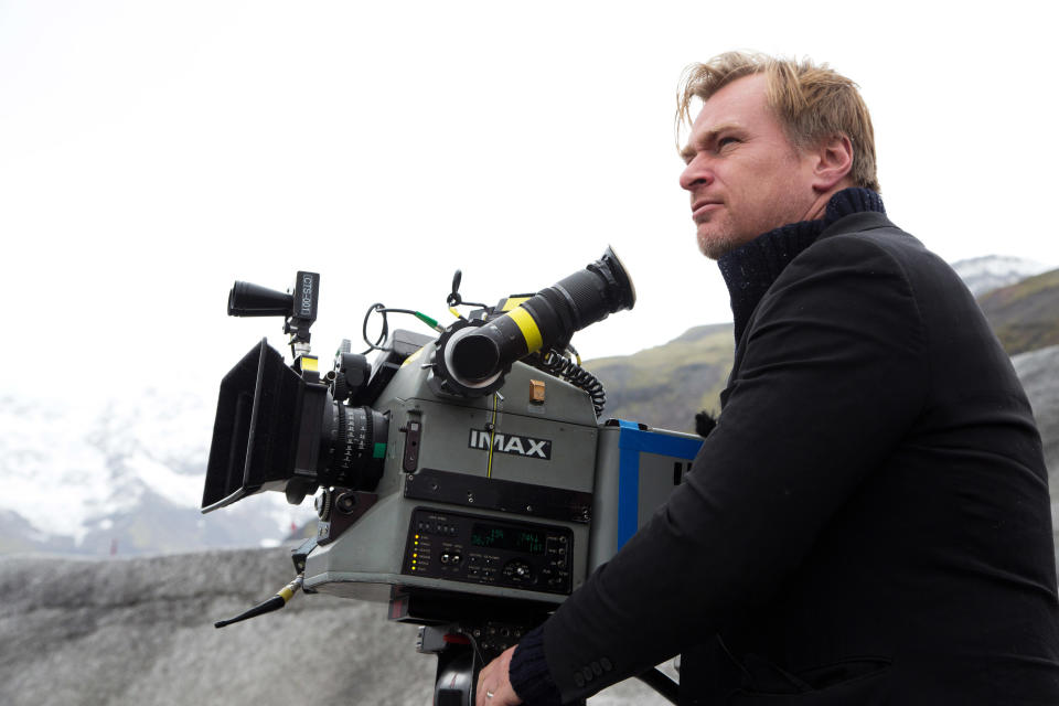 A director sits behind a camera