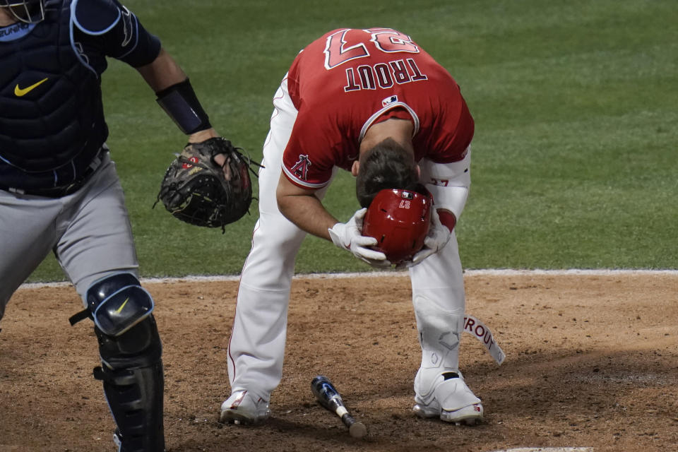 Los Angeles Angels' Mike Trout removes his helmet after striking out during the eighth inning of the team's baseball game against the Tampa Bay Rays, Thursday, May 6, 2021, in Anaheim, Calif. (AP Photo/Jae C. Hong)
