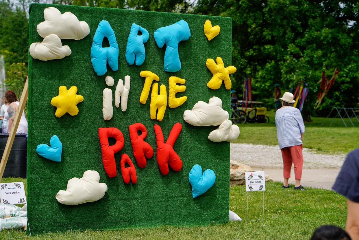 An artful sign welcomes visitors to Art in the Park 2022