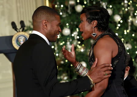 Singer Usher (L) attends the 2015 Kennedy Center Honors Reception at the White House in Washington December 6, 2015. REUTERS/Yuri Gripas