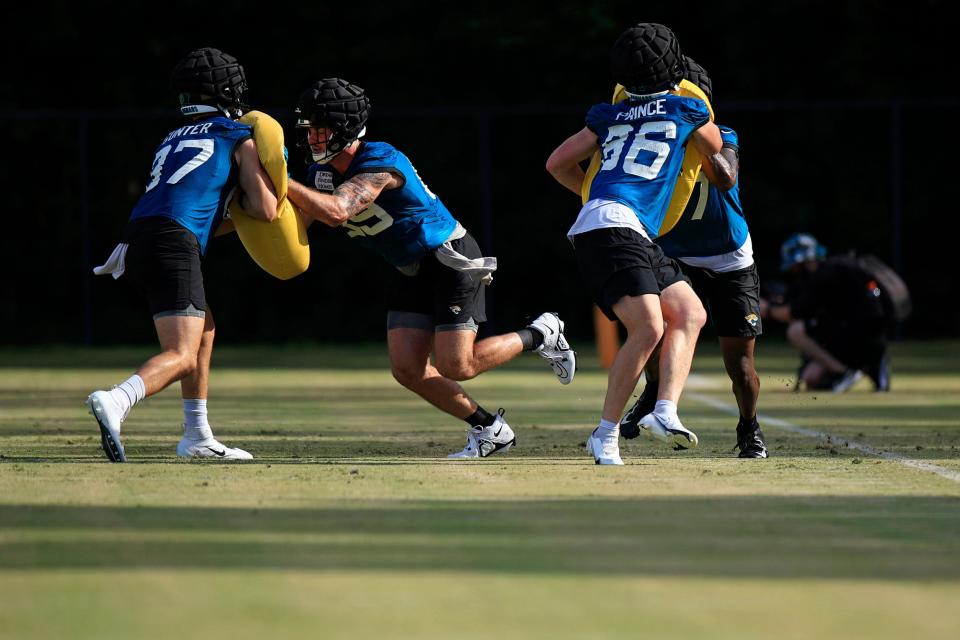 From left, Jacksonville Jaguars tight ends Grayson Gunter (87), Luke Farrell (89), Grayson Gunter (87) and Naz Bohannon (47) drill with blocking pads during day 2 of the Jaguars Training Camp Tuesday, July 26, 2022 at the Knight Sports Complex at Episcopal School of Jacksonville. 