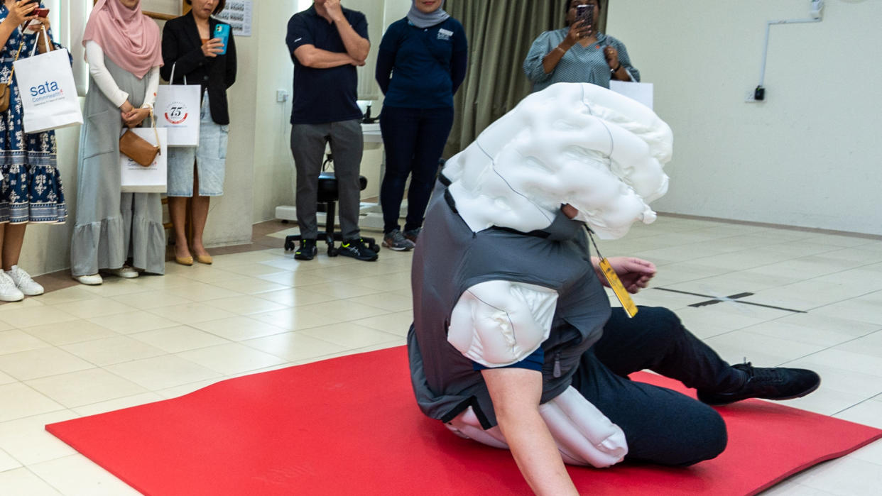 A picture of a person testing an airbag meant for falling individuals.
