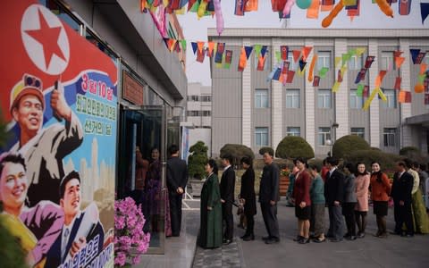 Voters queue to cast their ballots at the '3.26 Pyongyang Cable Factory' during voting for the Supreme People's Assembly elections, in Pyongyang - Credit: &nbsp;ED JONES/AFP