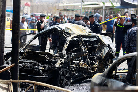 A wreckage of a car is seen at the site of car bomb attack near a government office in Karkh district in Baghdad, Iraq May 30, 2017. REUTERS/Khalid al-Mousily