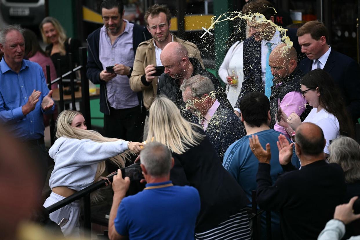 Right-wing British politician Nigel Farage is hit in the face with a milkshake during his general election campaign launch in Clacton-on-Sea, eastern England, on June 4, 2024. <span>Photo by BEN STANSALL/AFP via Getty Images</span>