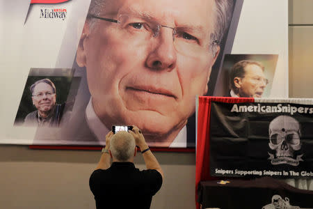 An attendee stops to take a photograph of the National Rifle Association (NRA) chief executive Wayne LaPierre before the association's annual meeting in Dallas, Texas, U.S., May 4, 2018. REUTERS/Lucas Jackson