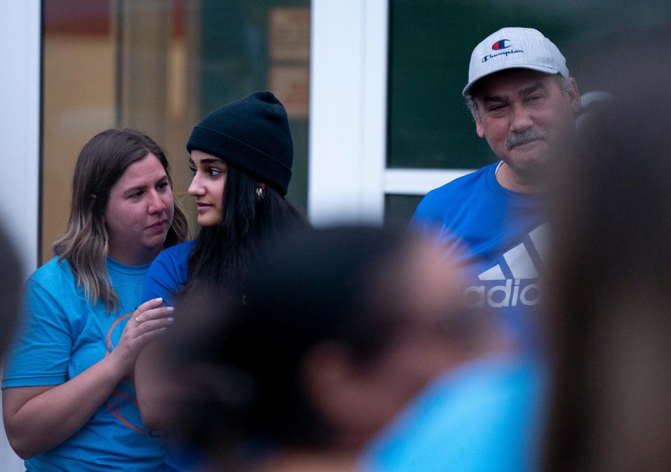 Missy Wood, Yousuf Ayesh's fifth grade teacher, speaks with his sister, Noor Ayesh, 16, during the vigil held for him at Black Fox Elementary in Murfreesboro, Tenn., Friday, May 17, 2024. The 11-year-old died Tuesday after being diagnosed with cancer in autumn of last year. More than 200 members of the community showed up to celebrate and remember the well-loved fifth-grader. Yousuf's father, Hussam Ayesh, is also pictured.
