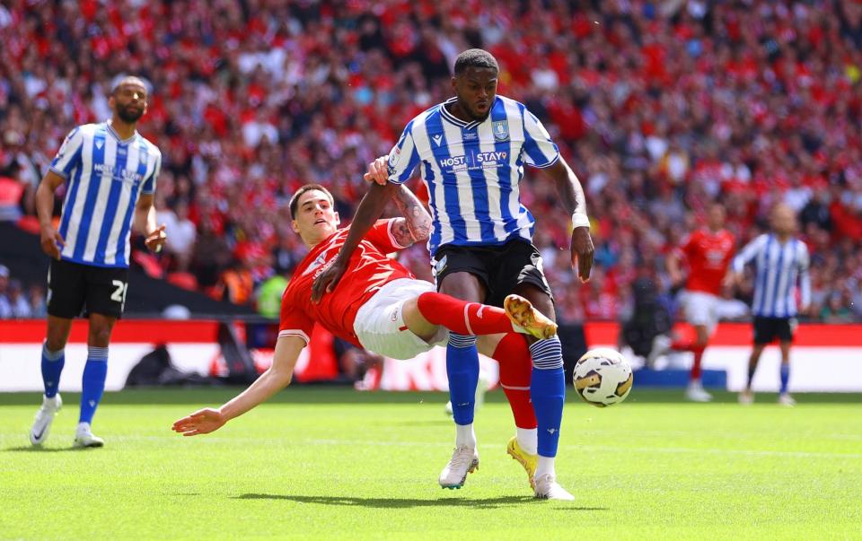 Battle! Dominic Iorfa of Sheffield Wednesday is challenged by Slobodan Tedic of Barnsley - Getty