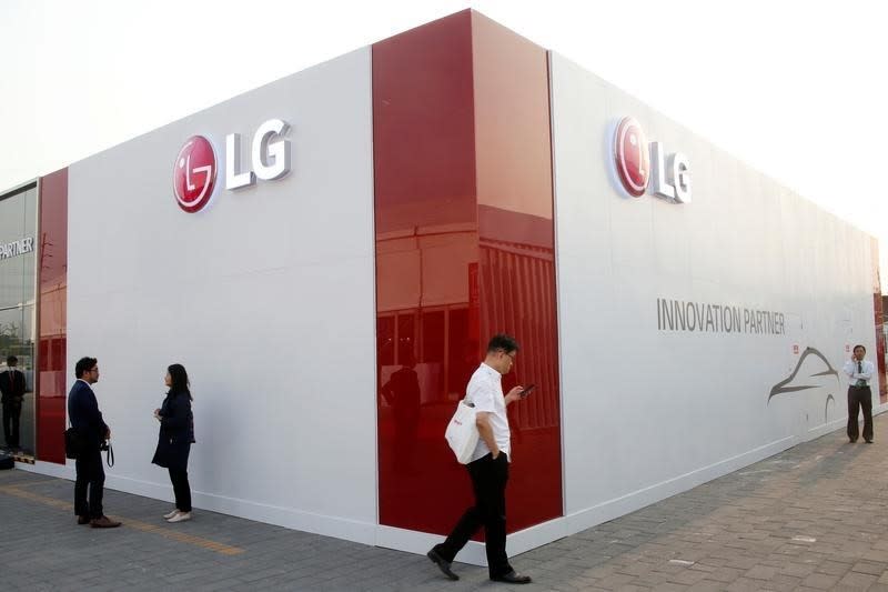 Visitors walk past the showroom of LG Electronics during the Auto China 2016 show in Beijing, China April 26, 2016. REUTERS/Kim Kyung-Hoon