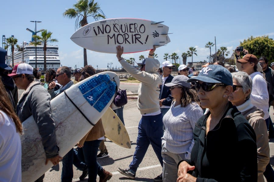 A demonstrator holding a bodyboard written in Spanish ” I don’t want to die” protests the disappearance of foreign surfers in Ensenada, Mexico, Sunday, May 5, 2024. Mexican authorities said Friday that three bodies were recovered in an area of Baja California near where two Australians and an American went missing last weekend during an apparent camping and surfing trip. (AP Photo/Karen Castaneda)
