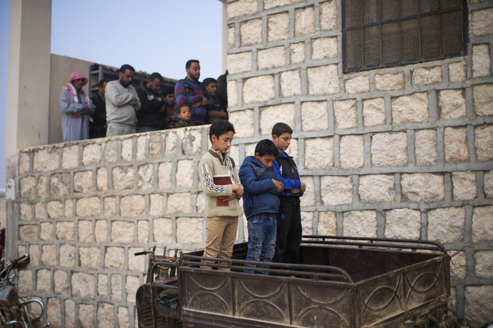 Syrians pray in a refugee camp for displaced people run by the Turkish Red Crescent in Sarmada district on the outskirts north of Idlib, Syria, Friday, Nov. 26, 2021. In this opposition-held town near the border with Turkey, thousands of displaced Syrians go about their daily lives with little hope of returning home any time soon. (AP Photo/Francisco Seco)