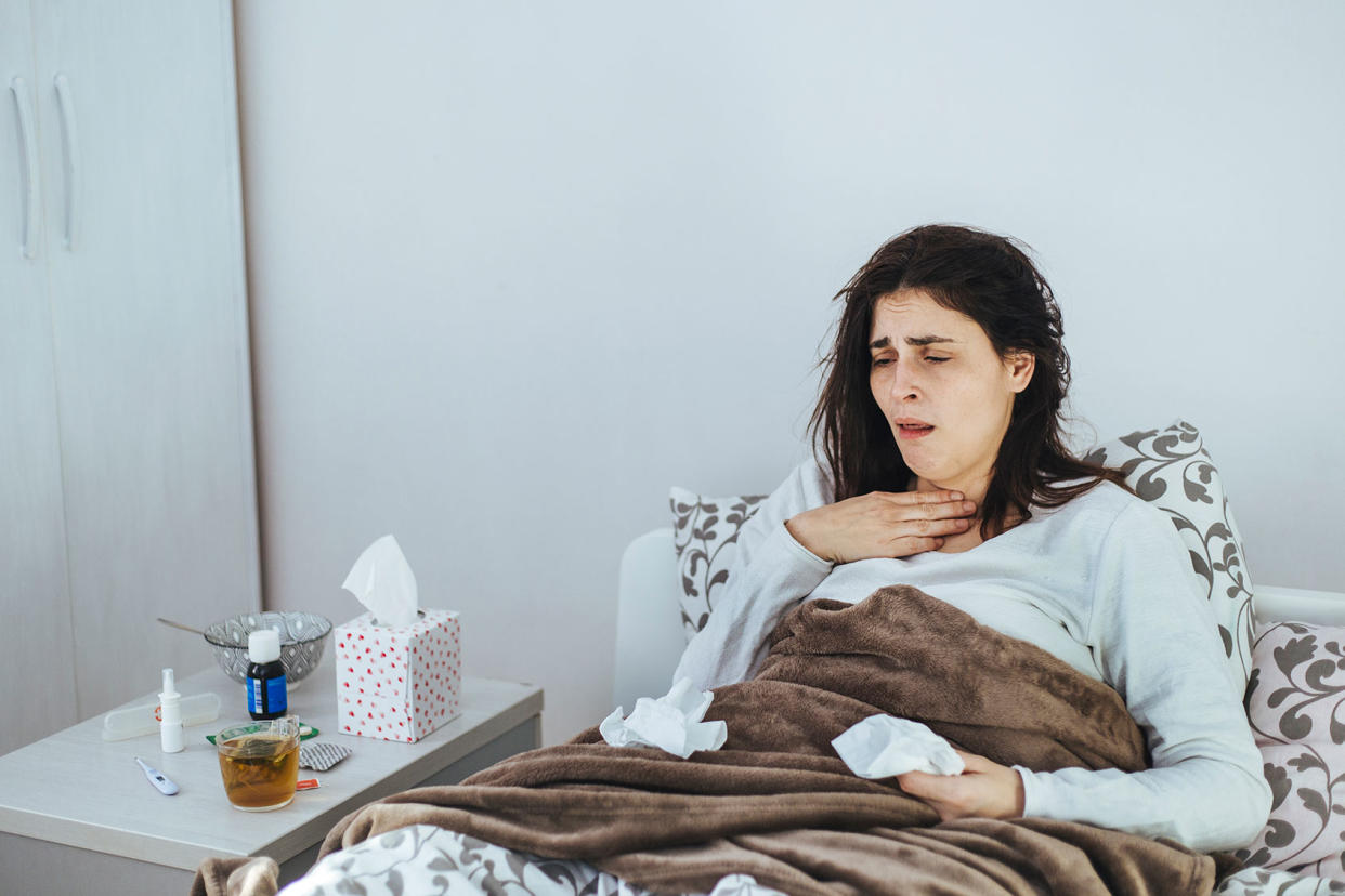 Woman Suffering From A Cold Lying In Bed Getty Images/Obradovic