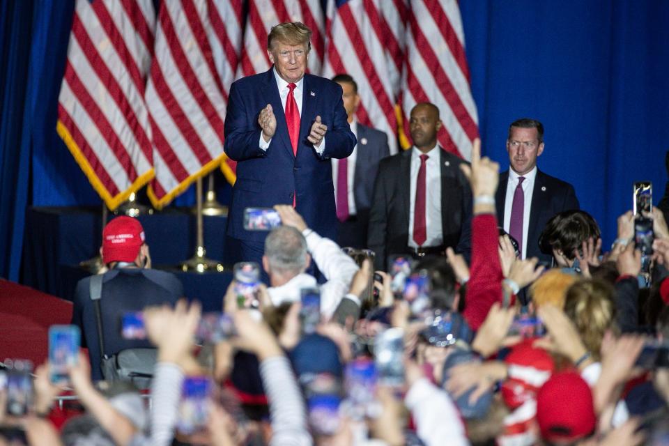 Former President Donald Trump waves at supporters before speaking during a Save America rally at the Michigan Stars Sports Center in Washington Township on April 2, 2022.