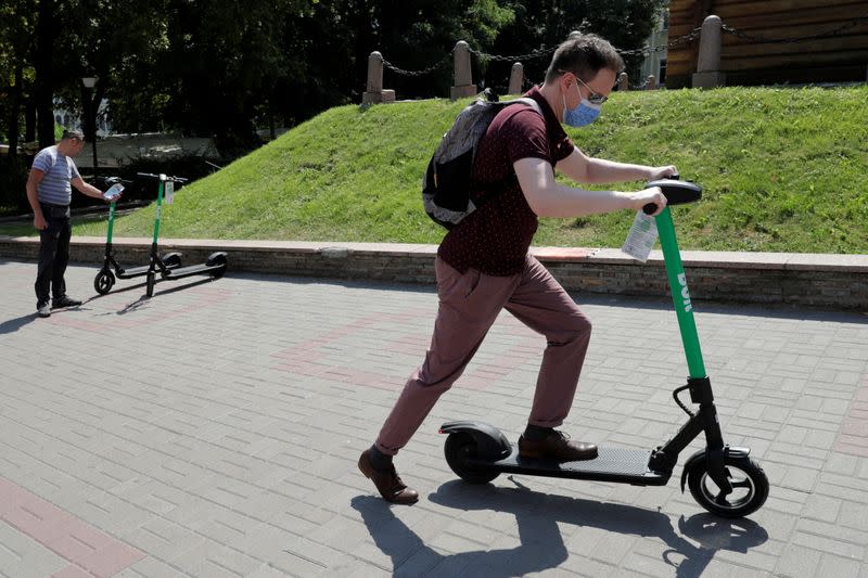 FILE PHOTO: A man uses an e-scooter from provider Bolt in central Kyiv