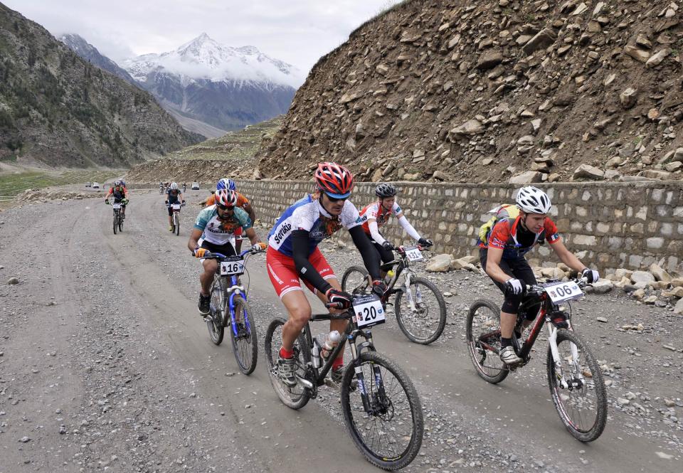 International and local Pakistani cyclists compete during the first stage of the Himalayas 2011 International Mountainbike Race in the mountainous area of Jalkhand in Pakistan's tourist region of Naran in Khyber Pakhtunkhwa province on September 16, 2011. The cycling event, organised by the Kaghan Memorial Trust to raise funds for its charity school set up in the Kaghan valley for children affected in the October 2005 earthquake, attracted some 30 International and 11 Pakistani cyclists. AFP PHOTO / AAMIR QURESHI (Photo credit should read AAMIR QURESHI/AFP/Getty Images)