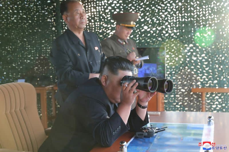 FILE PHOTO: KCNA picture of North Korean leader Kim Jong Un attending the test of a multiple rocket launcher