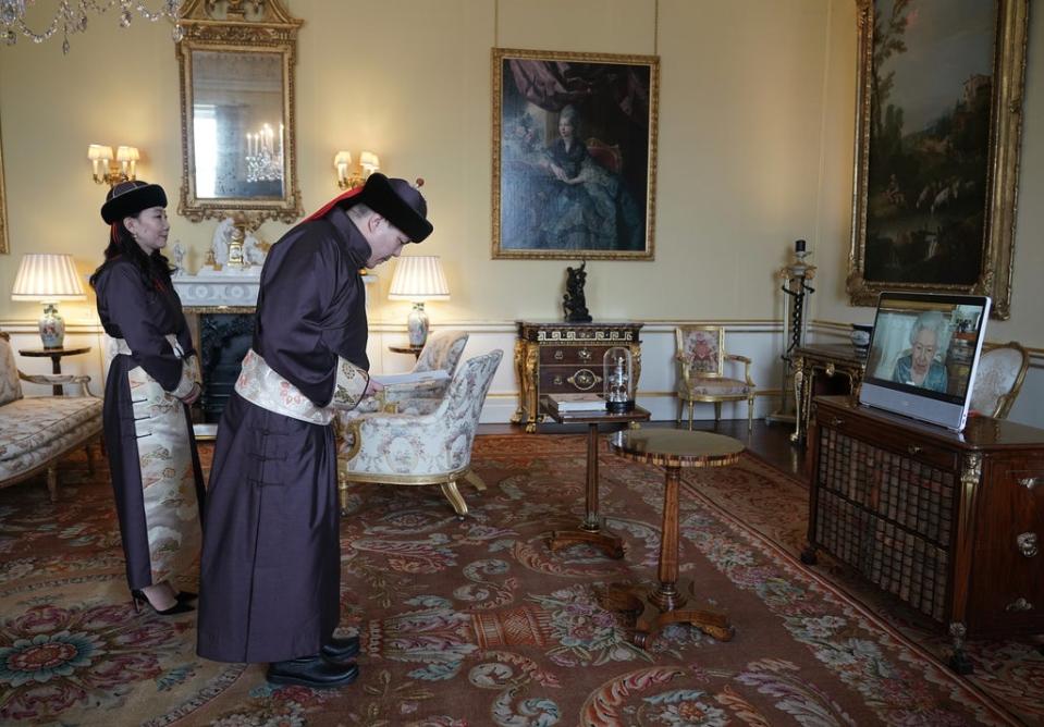 Enkhsukh Battumur, Ambassador of Mongolia, and his wife Ganchimeg Purevdorj, are received by the Queen via video-link (Yui Mok/PA) (PA Wire)