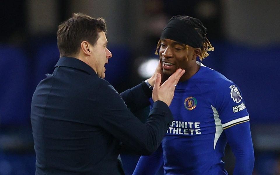 A relieved Maurico Pochettino congratulates the matchwinner Noni Madueke