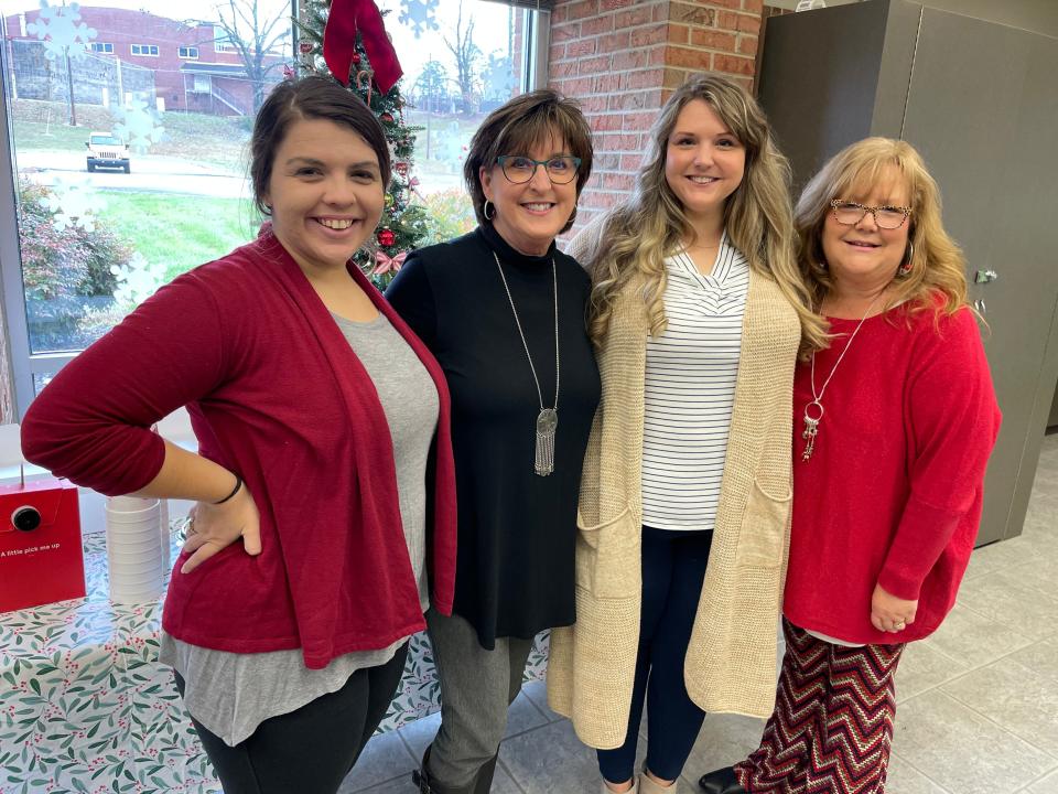 Inez Tackett (second from left) is fitting in with her new staff (from left): Mary Webb, Jessie Frey and Wendi Holder.