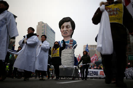 Members of Korean Confederation of Trade Unions march with an effigy of South Korean President Park Geun-hye during a general strike calling for Park to step down in central Seoul, South Korea, November 30, 2016. REUTERS/Kim Hong-Ji