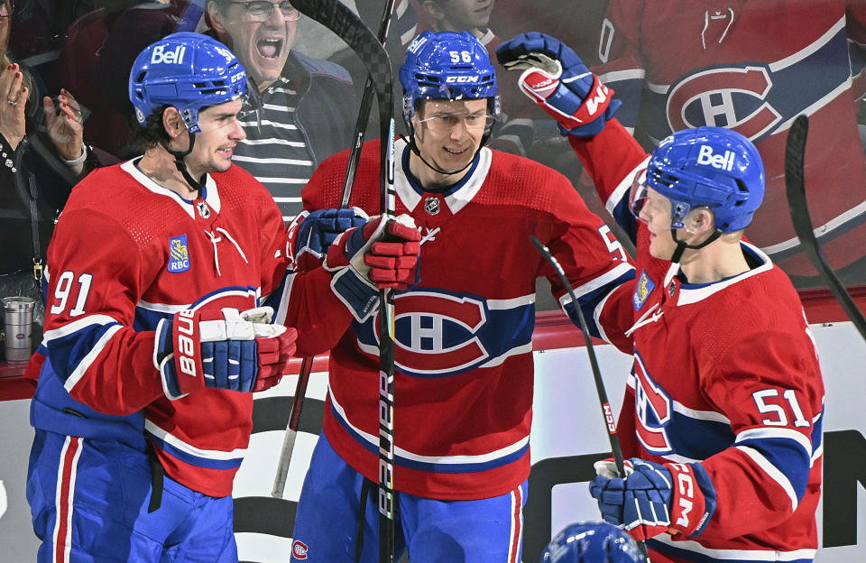 Montreal Canadiens' Jesse Ylonen (56) celebrates with teammates Sean Monahan (91) and Emil Heineman (51) after scoring against the New York Rangers during the second period of an NHL hockey game, Saturday, Jan. 6, 2024 in Montreal. (Graham Hughes/The Canadian Press via AP)
