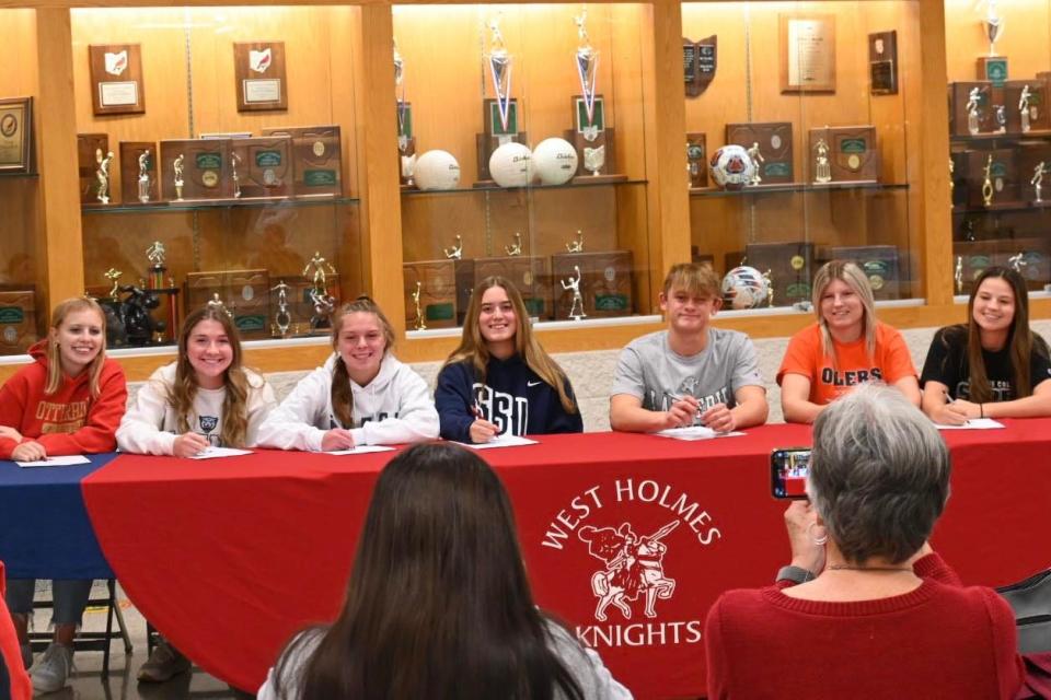 West Holmes seniors (L-R) Addison Yoder, Natalie Rohr, Allie McMillen, Keegan Uhl, Hunter Aurand, Kenzie Woods and Kali Woods pose for a picture together after their signing.