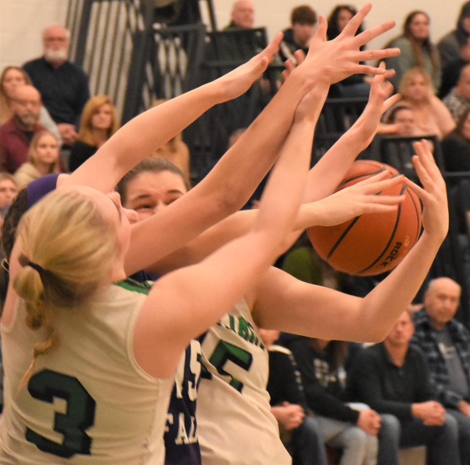 Herkimer Magicians Aubrey Lewis (3) and Bailey Bray battle Little Falls Mountie Olivia Brand for control of a loose ball during Saturday's Class C sctional game in Herkimer.