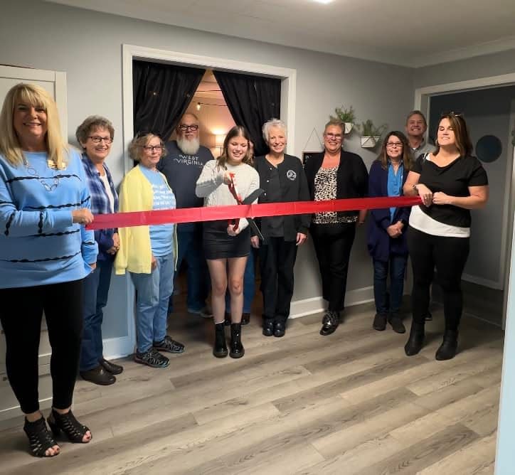 Emily Hypes cuts the ribbon for her new business, Esthetics by Emily.