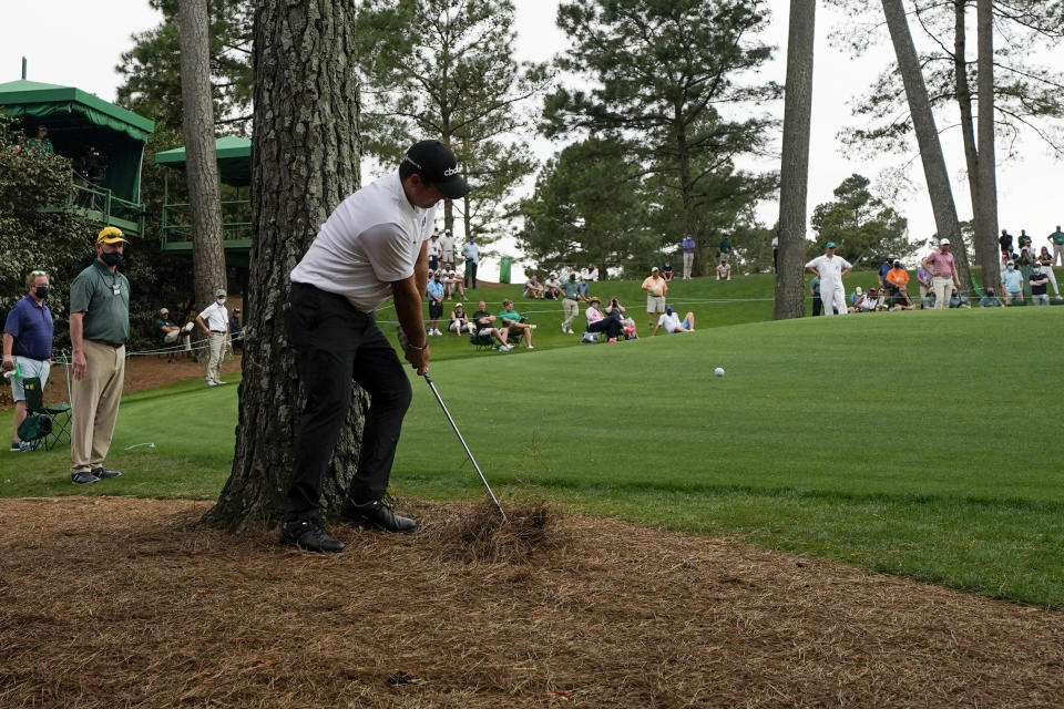 Patrick Reed hits out of the pine straw on the 10th hole during the second round of the Masters golf tournament on Friday, April 9, 2021, in Augusta, Ga. (AP Photo/Gregory Bull)